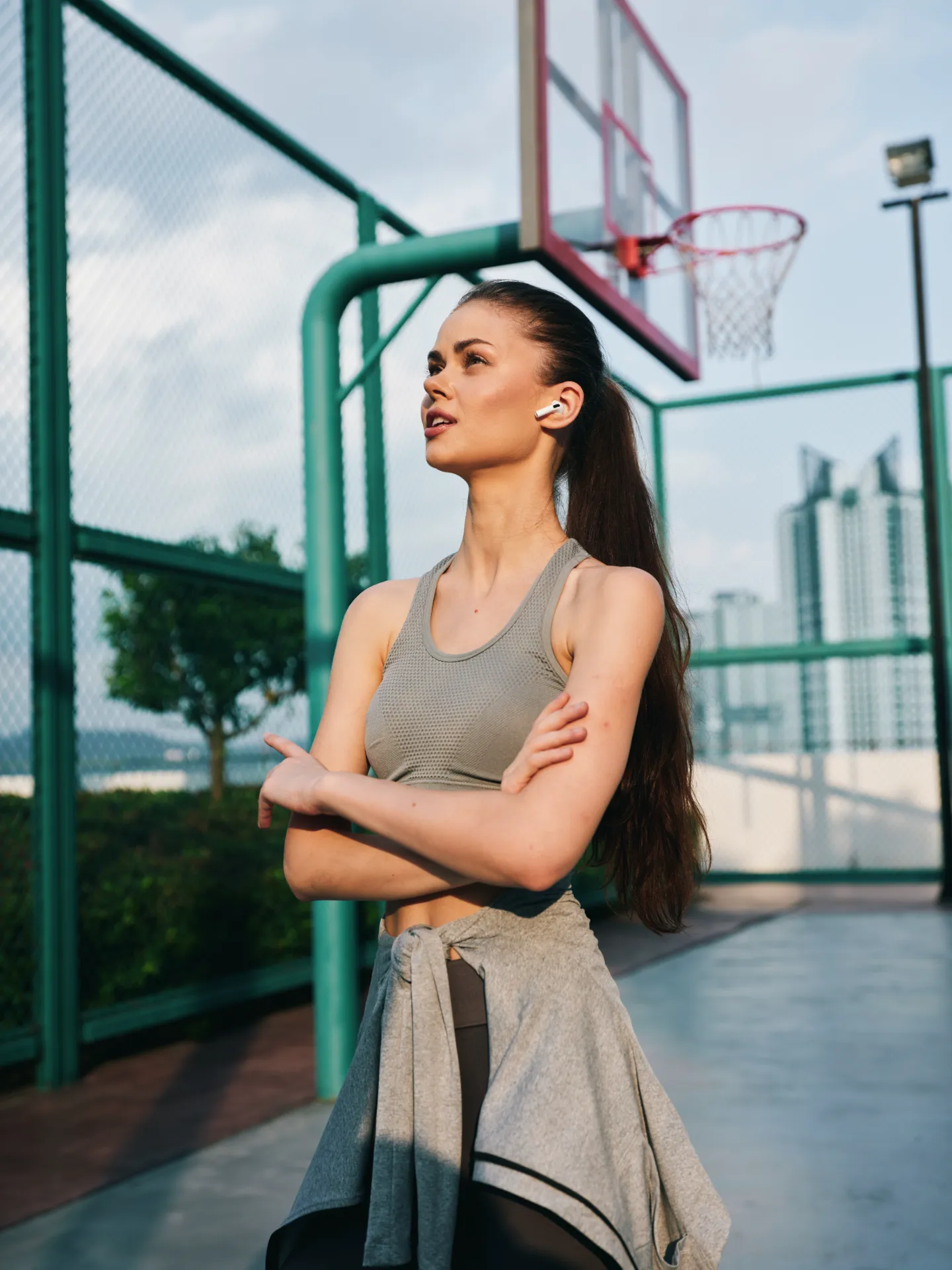 fit young woman resting on basketball court utc